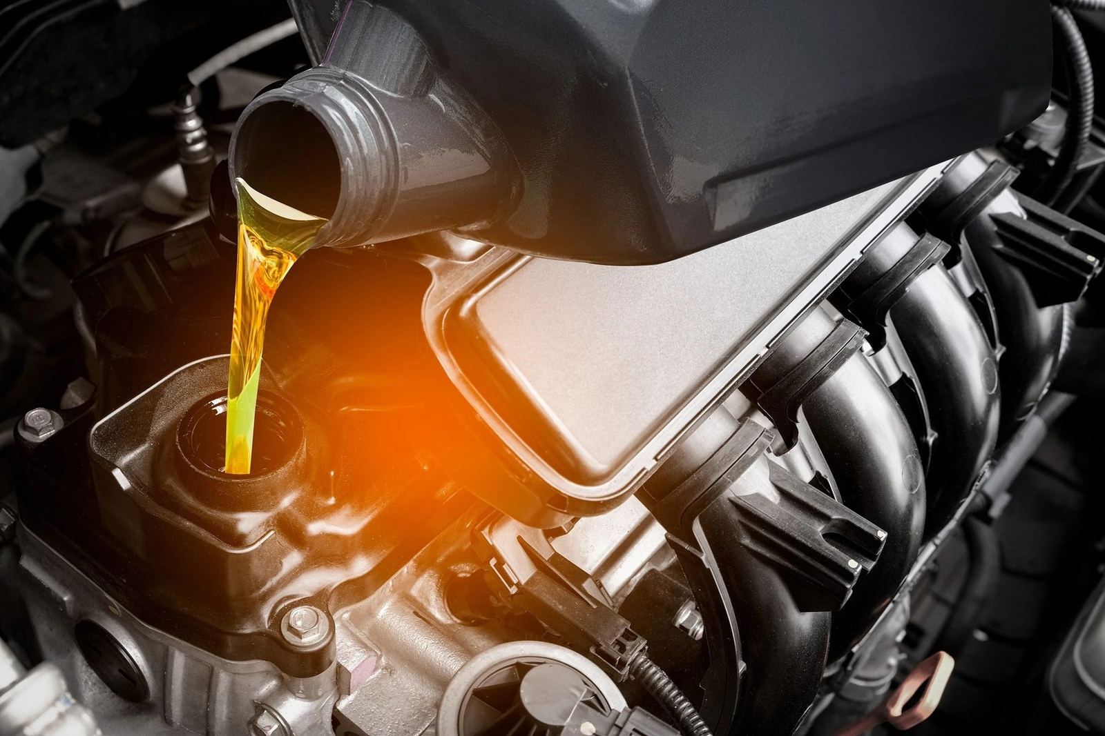 Fresh engine oil being poured into a diesel engine